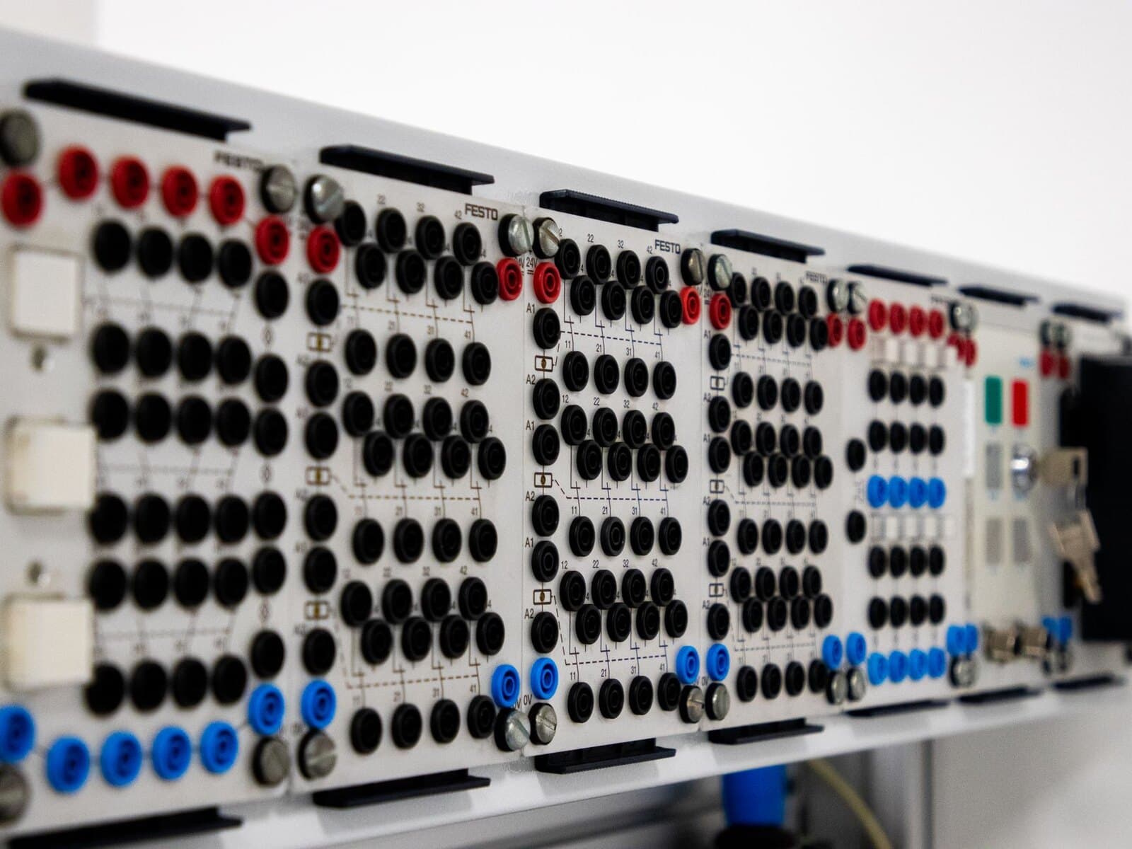 Modern industrial control panel with rows of connectors and buttons