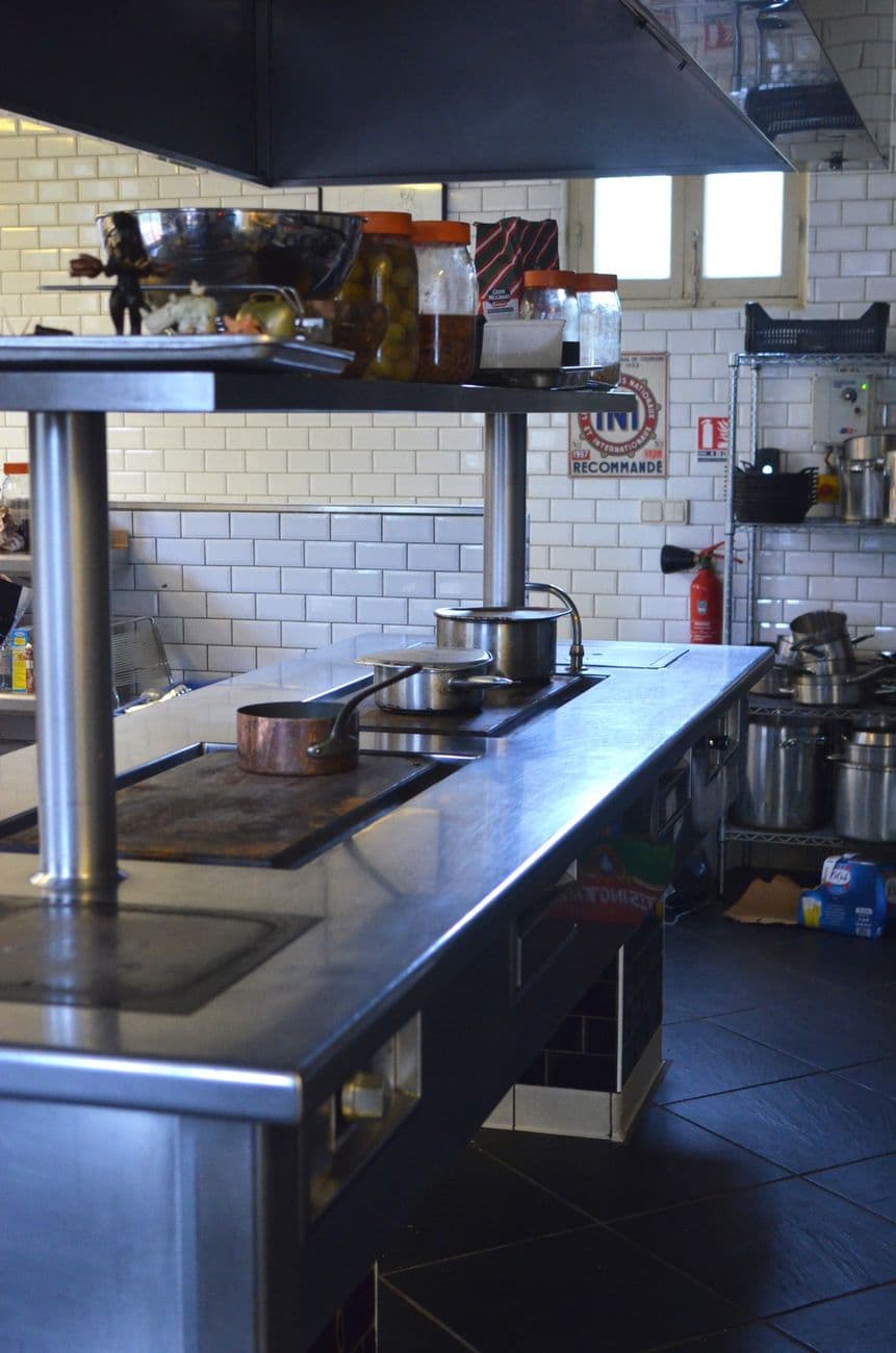 Commercial kitchen with stainless steel equipment lined in place