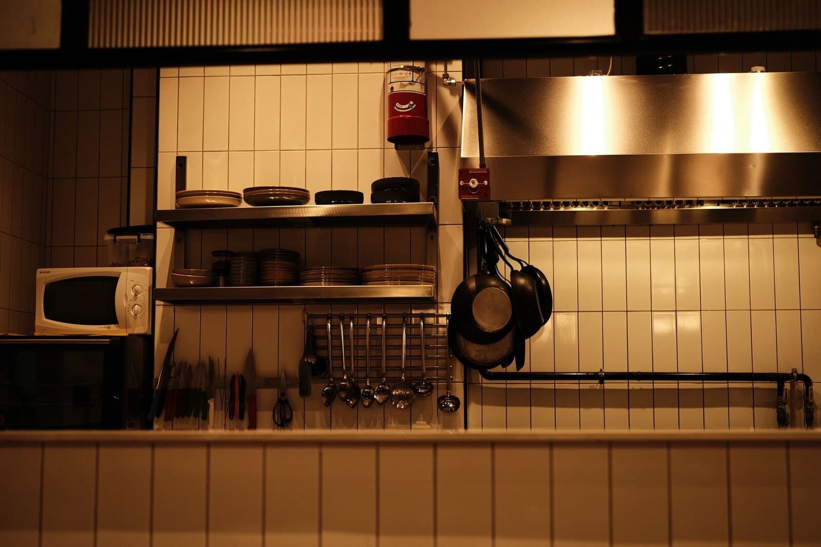 Stainless steel commercial kitchen hood and cooking line in a restaurant