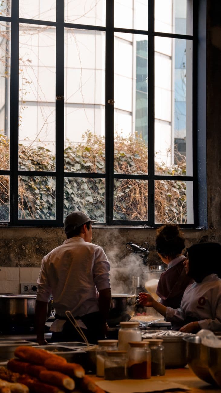 Chefs working together in a busy restaurant kitchen