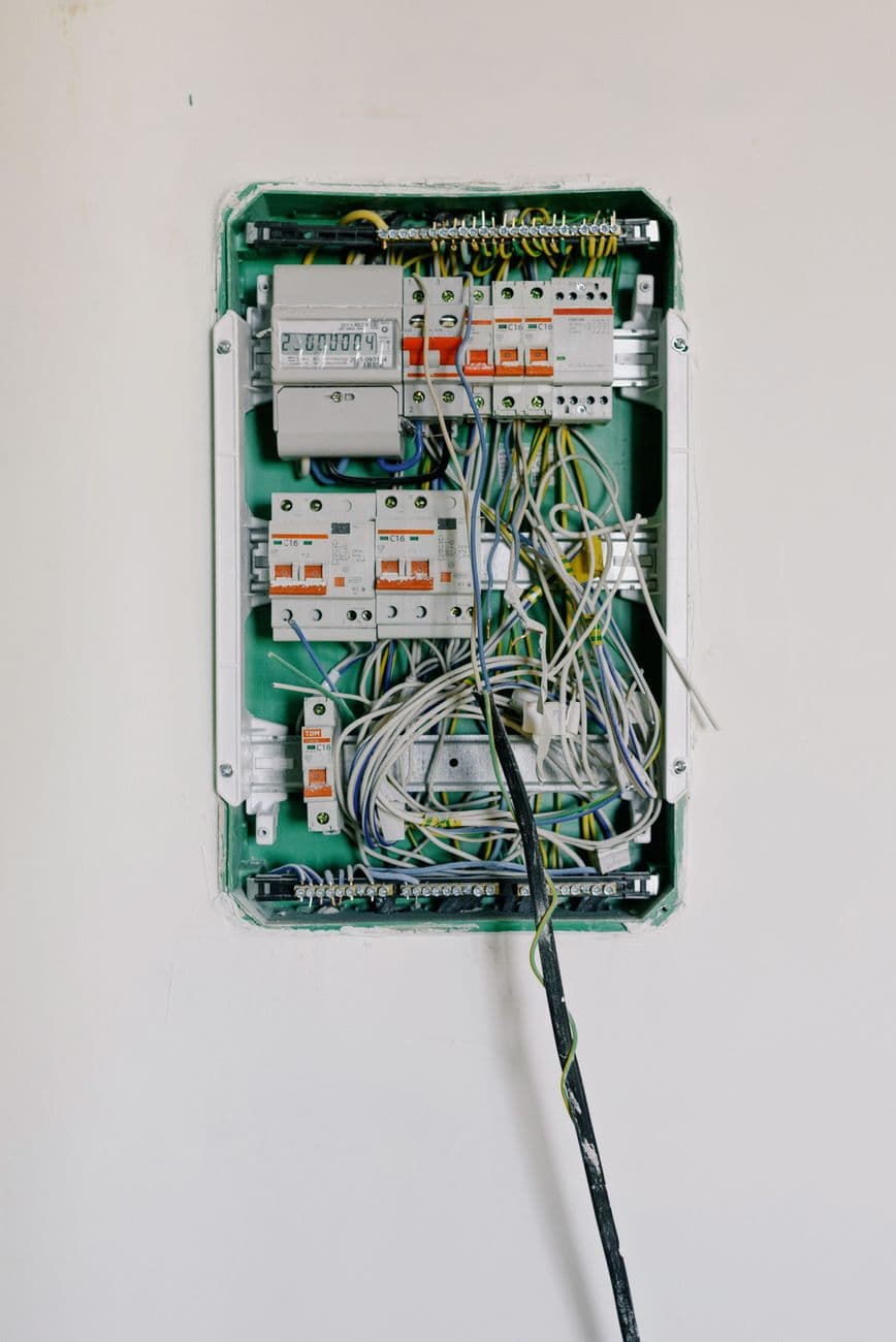 Electrician working on a commercial electrical breaker panel