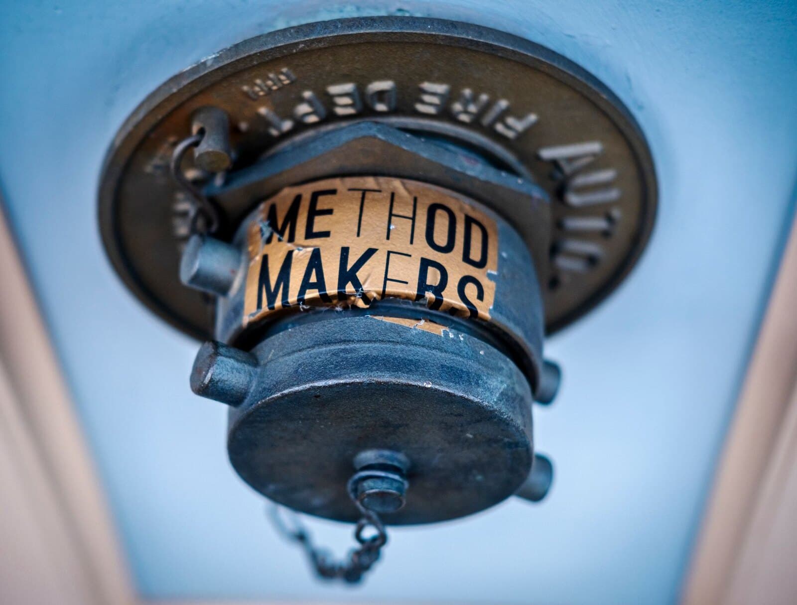 Close-up of a blue fire sprinkler head mounted in a ceiling