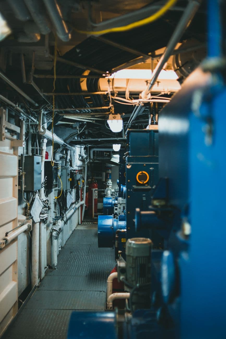Industrial machinery and piping inside a mechanical room