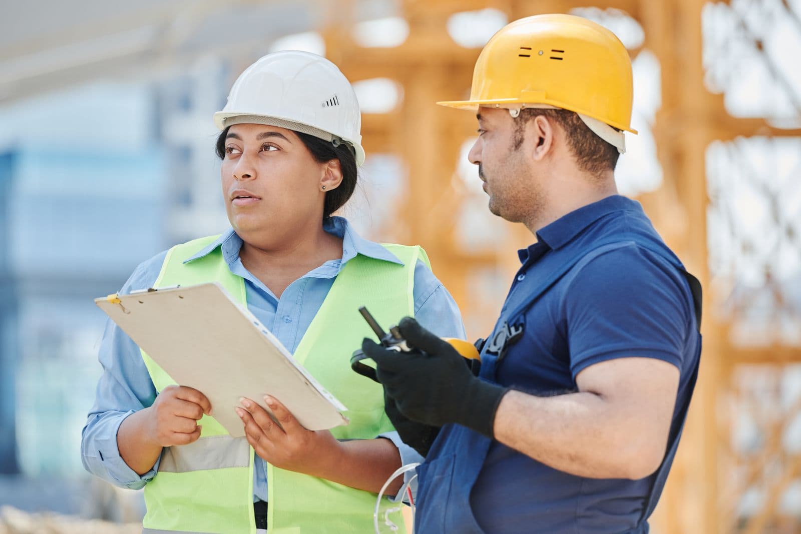 Two contractors reviewing project details together on a job site
